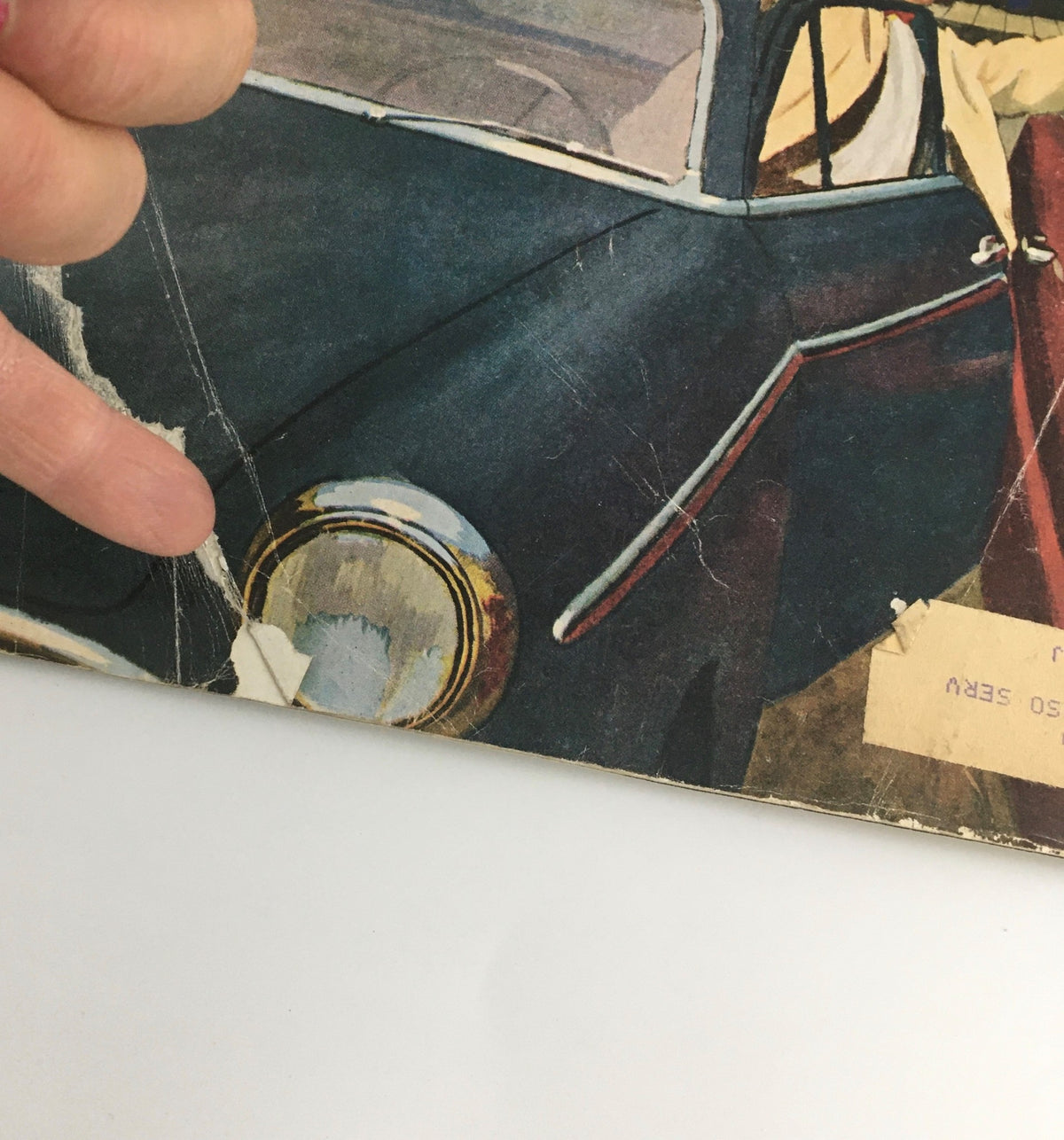 Close-up view of the edge of The Saturday Evening Post March 5 1960 magazine, showing wear and minor rips, highlighting its vintage character and authenticity.