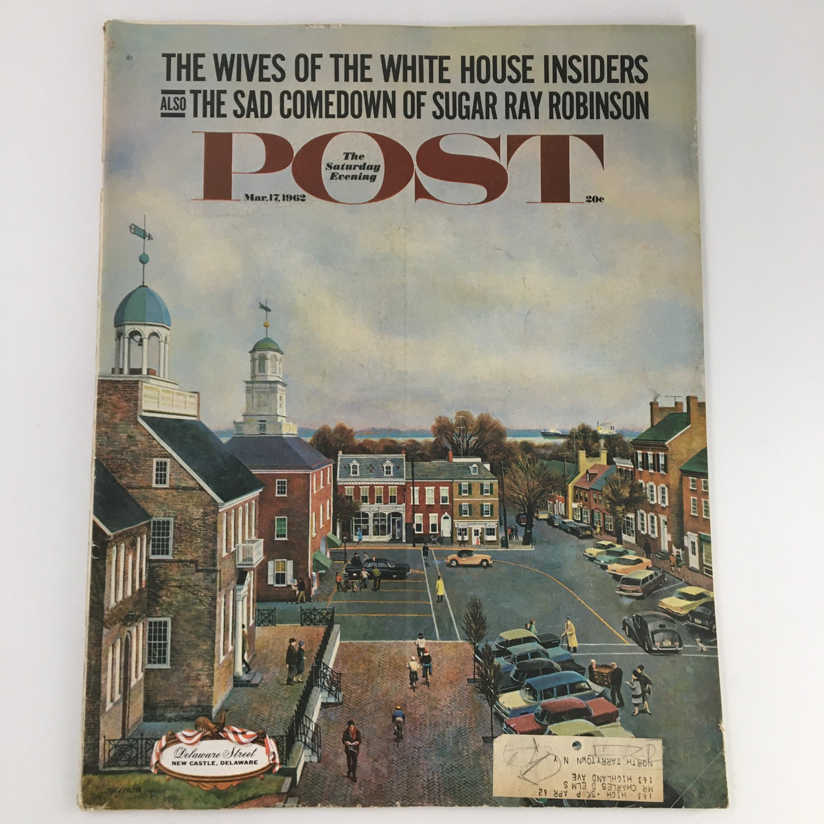 The Saturday Evening Post cover from March 17, 1962 showcasing an illustration of a town square scene with historical buildings, featuring the title 'The Wives of the White House Insiders' and 'The Sad Comedown of Sugar Ray Robinson' prominently displayed.