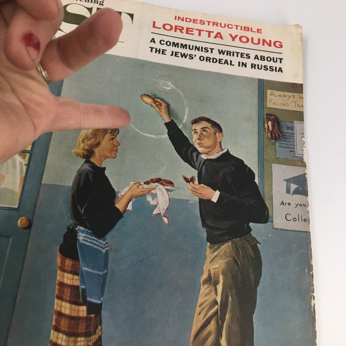 Close-up of The Saturday Evening Post cover from May 28, 1960, emphasizing the interaction between a man and a woman, with Loretta Young featured. Vintage magazine design.