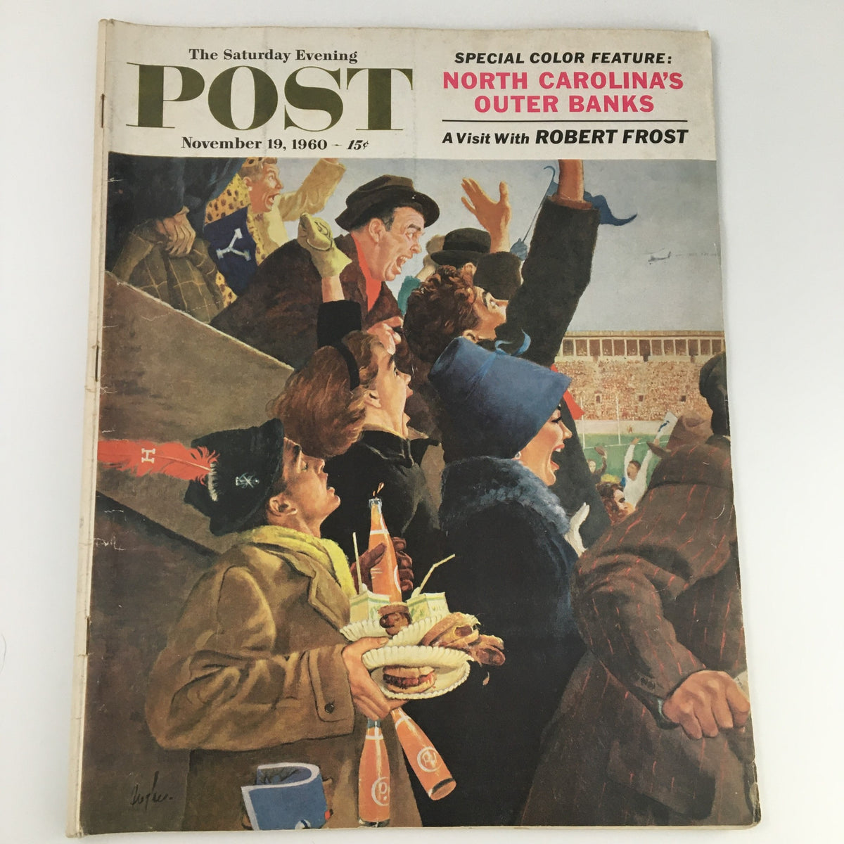 Cover of The Saturday Evening Post, November 19, 1960, featuring a colorful illustration of a crowd during a sports event, highlighting a visit with Robert Frost and including a special color feature on North Carolina's Outer Banks.
