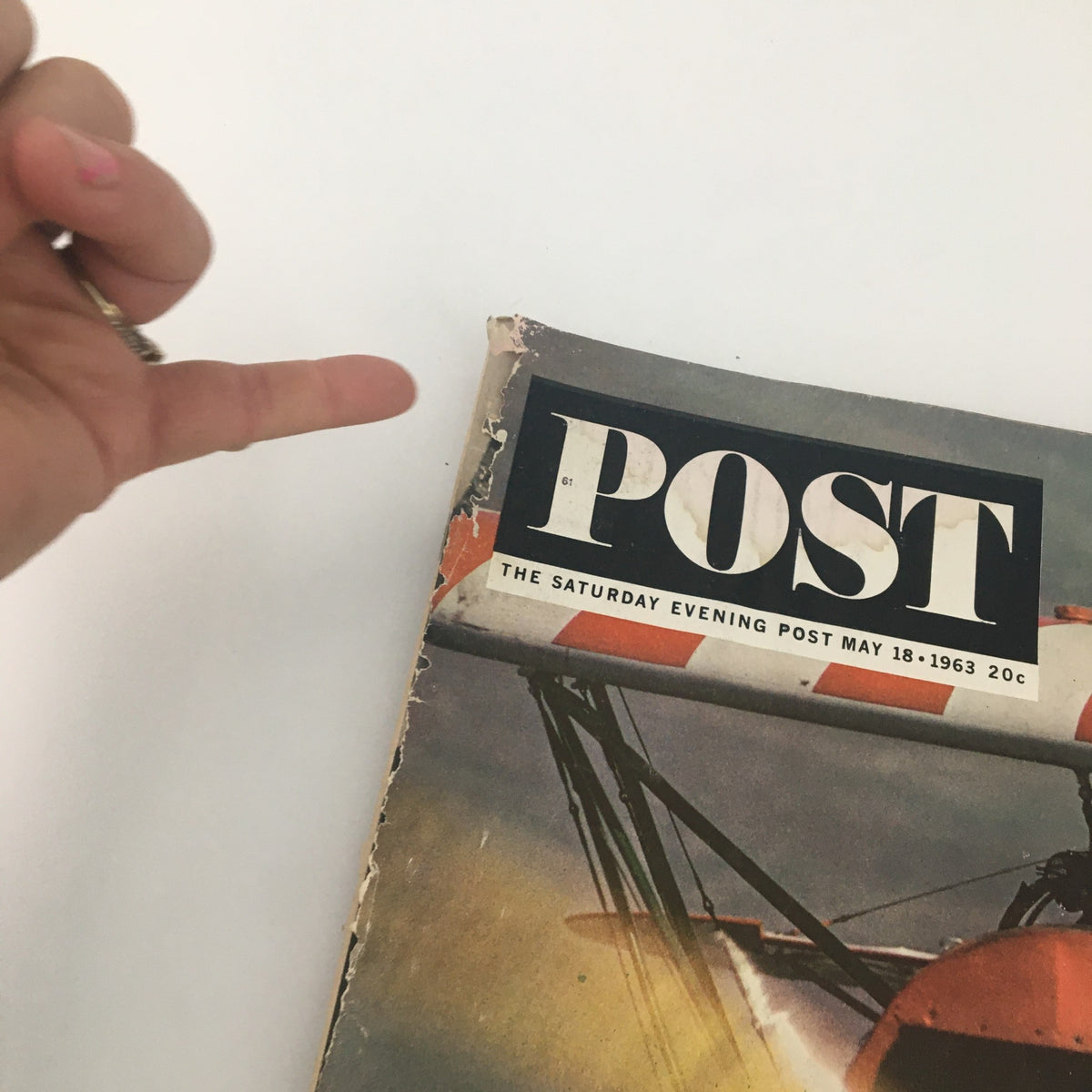A close-up view of the cover of The Saturday Evening Post dated May 18, 1963, emphasizing the title 'Spending Into Trouble' while highlighting wear and vintage character.