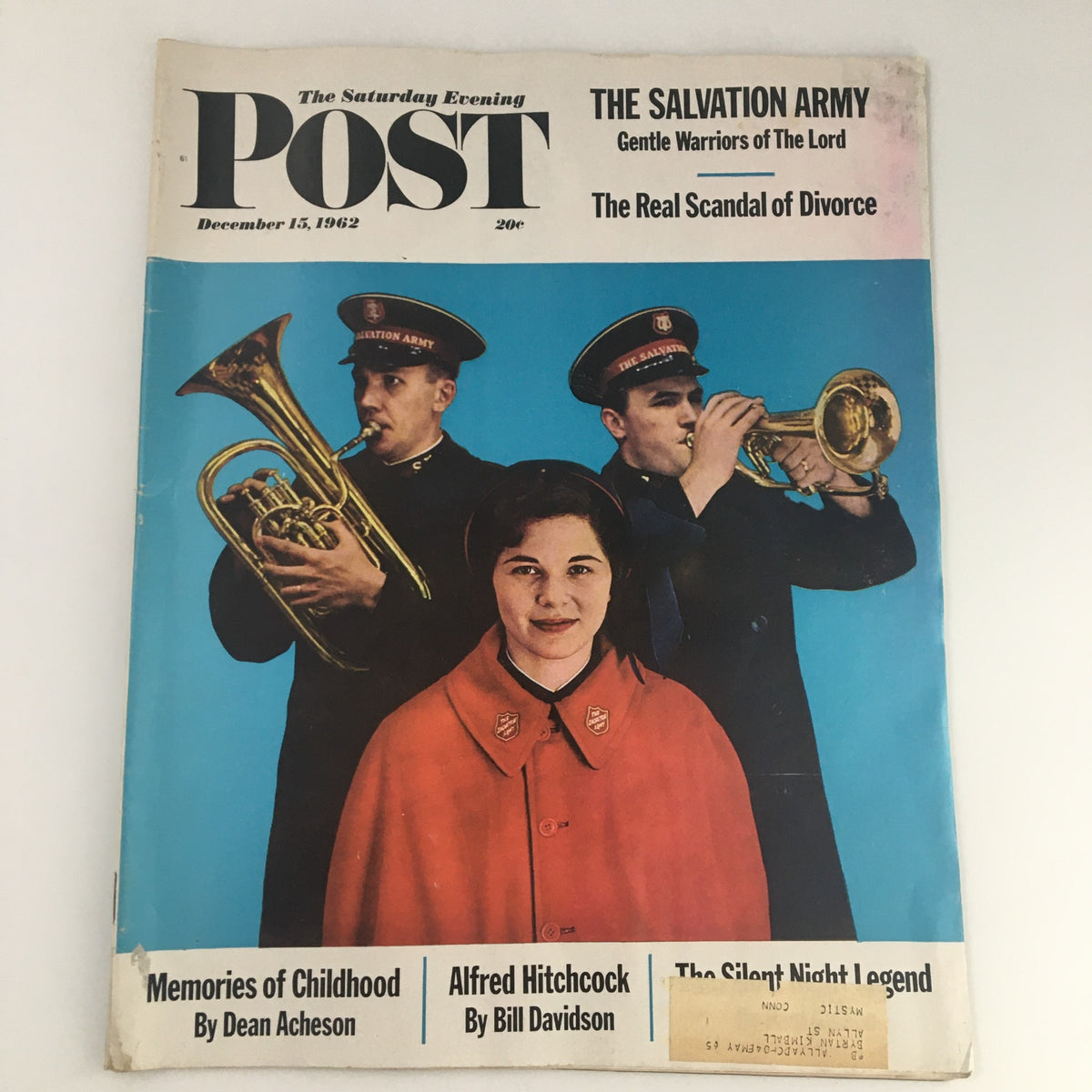 Cover of The Saturday Evening Post from December 15, 1962, featuring The Salvation Army with musicians playing instruments and a woman in a red coat. Displays cultural themes of the 1960s.
