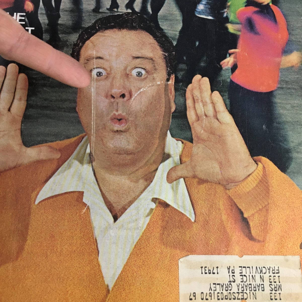 Detailed view of the surprised man in an orange sweater from The Saturday Evening Post February 11 1967 cover, emphasizing his expression and the address label on the magazine.
