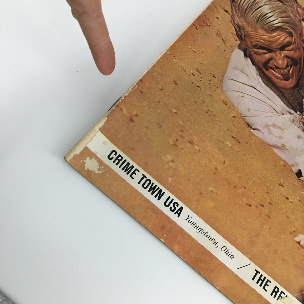 Close-up view of the edge of The Saturday Evening Post March 9 1963 featuring Peter O'Toole cover and an article about Crime Town USA, showcasing minor wear and an address label.