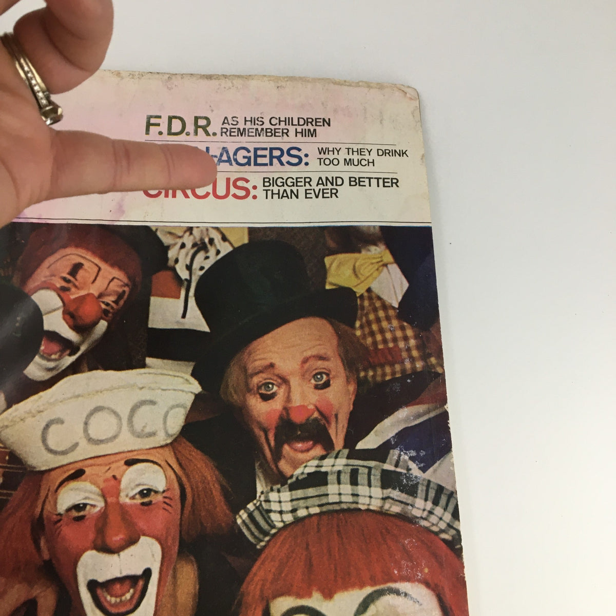 Detailed view of The Saturday Evening Post April 10 1965 cover, focusing on clown characters and highlighted articles including FDR's legacy.