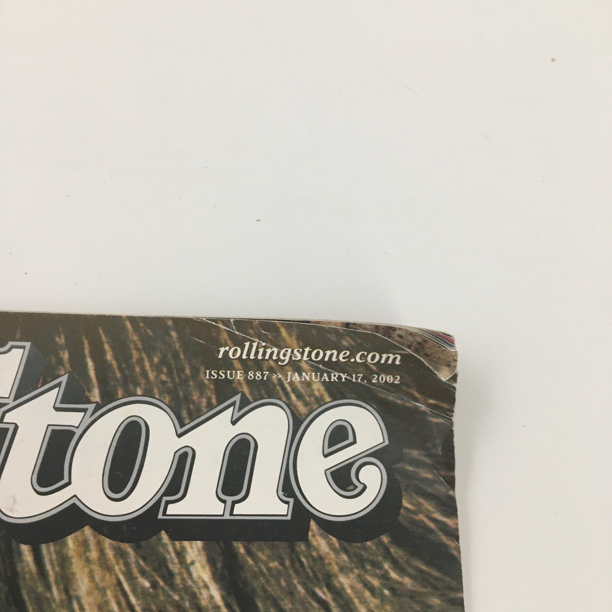 Detail of Rolling Stone Magazine January 17 2002 #887 logo and publication date, showcasing some minor wear.