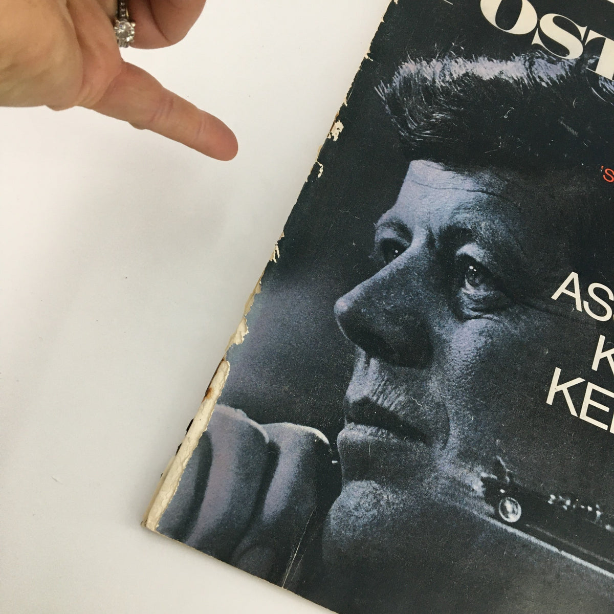 Detailed view of The Saturday Evening Post cover from December 2, 1967 highlighting the title 'The John F. Kennedy Tragedy Feature'. The image shows John F. Kennedy's profile with minor wear and a hand gesturing towards the magazine.