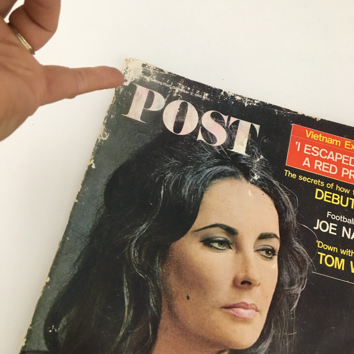 Close-up of The Saturday Evening Post December 3 1966 magazine cover showing details of Elizabeth Taylor with hand pointing at magazine title.