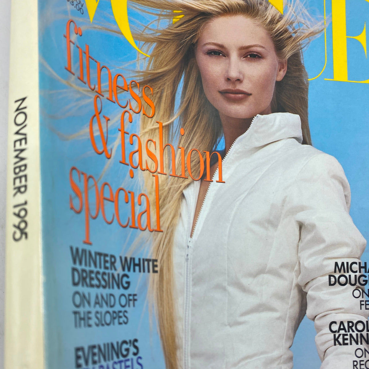 Close-up view of the Vogue Magazine November 1995 cover, showcasing a model with long blonde hair in a white jacket and the magazine's title prominently featured.