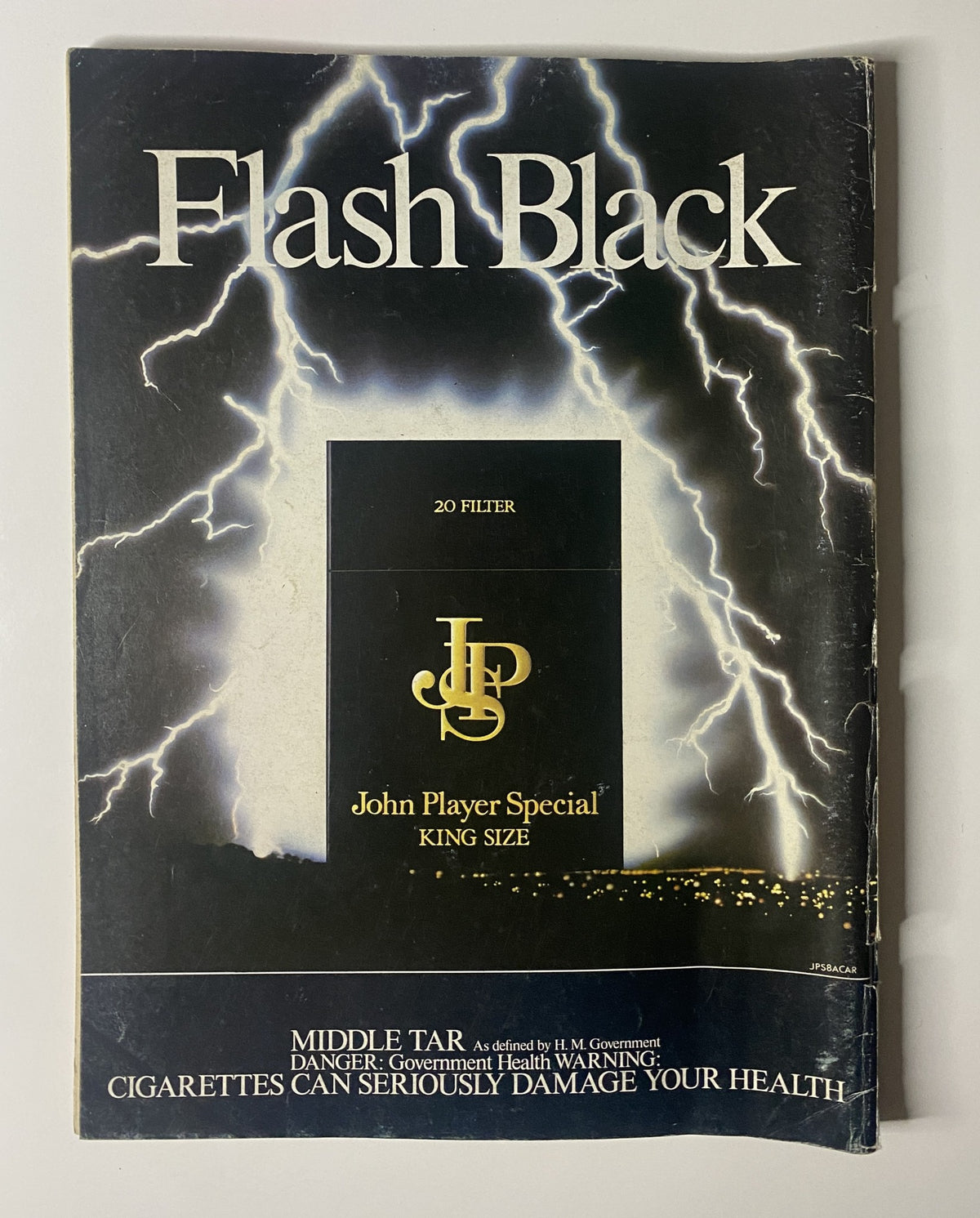 Advertisement for Flash Black cigarettes from the October 1983 issue of Car Magazine, emphasizing health warnings related to tobacco products.