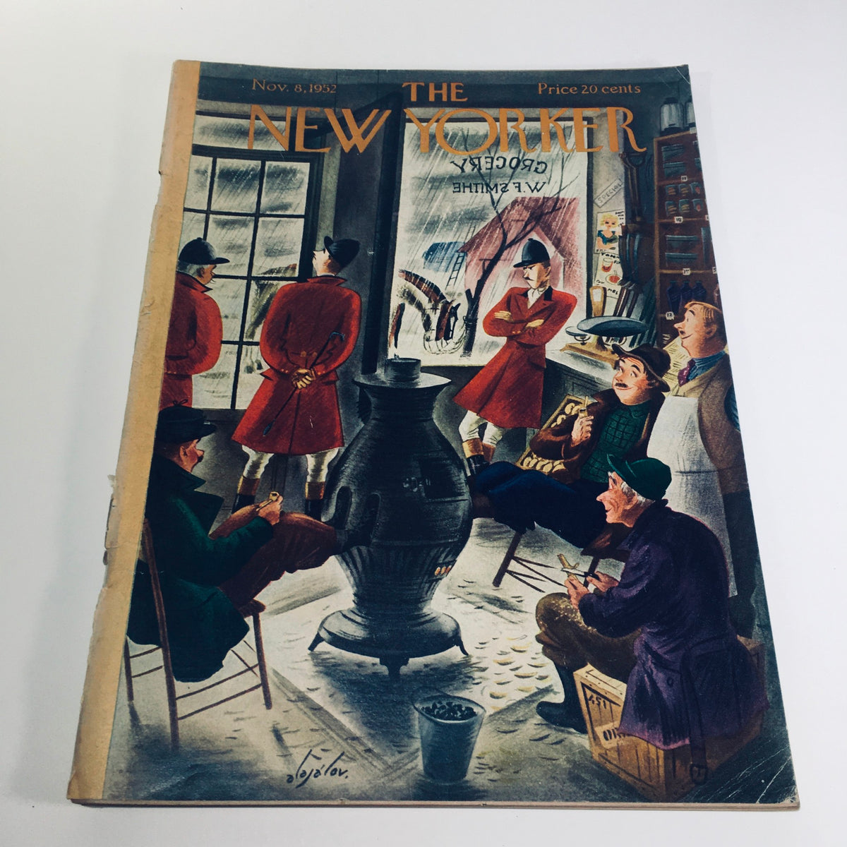 The New Yorker: November 8 1952 - Full Magazine cover featuring an artistic illustration by Constantin Alajalov, depicting men in red coats gathered around a warm stove, capturing the essence of mid-20th century American culture.