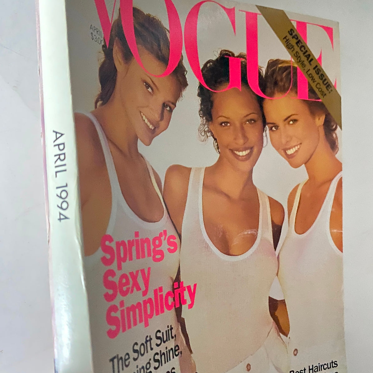 Side view of the Vogue Magazine April 1994 cover showcasing models Bridget Hall, Niki Taylor, and Brandi Quinones with the text 'Spring’s Sexy Simplicity.'