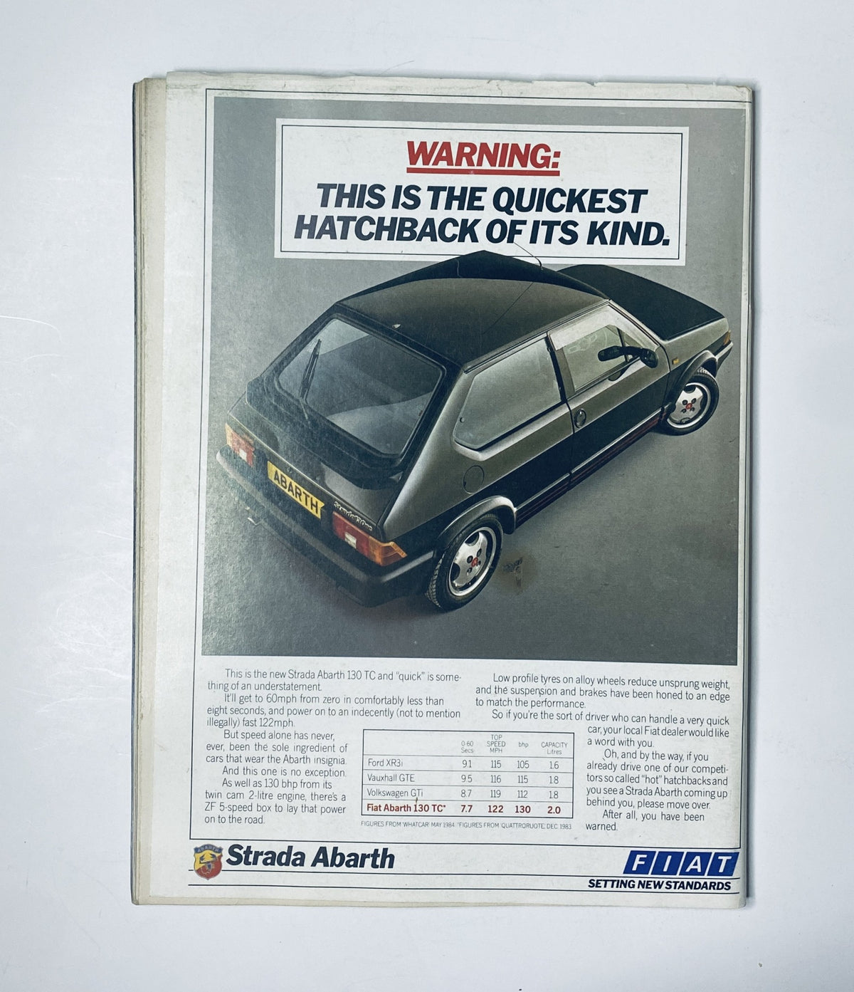 Advertisement for the Fiat Abarth 130TC featuring the text 'WARNING: THIS IS THE QUICKEST HATCHBACK OF ITS KIND.' The ad showcases the vehicle's sporty design, emphasizing its performance in the automotive market. Featured in Car Magazine September 1984 along with articles about the Golf GTI, Toyota MR2, and Porsche 231bhp.