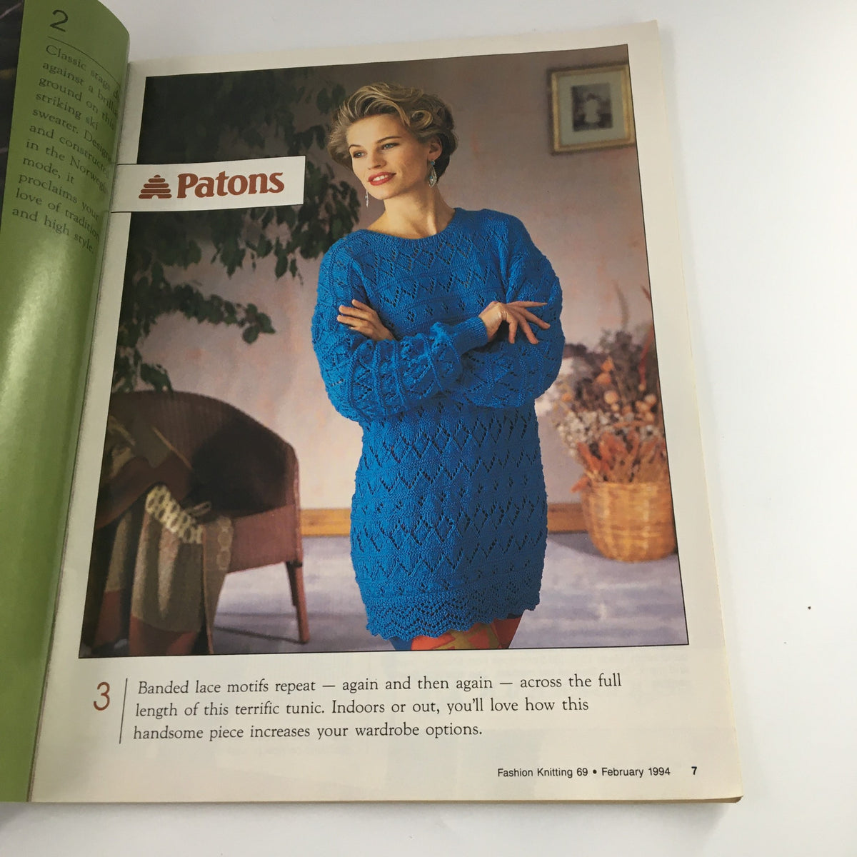 Interior page from Fashion Knitting Magazine February 1994 #69 featuring a blue knitted tunic styled by a woman, demonstrating the fashion trends of the time.