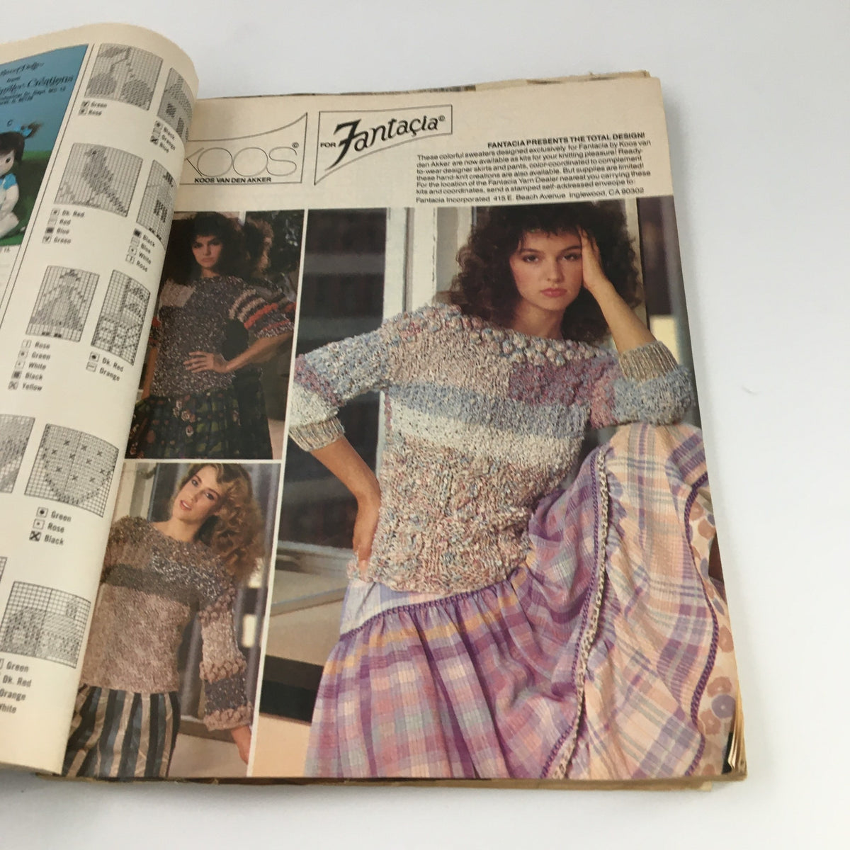 McCall's Needlework & Crafts Magazine February 1983 showcases a model wearing a colorful crochet sweater alongside various knitting pattern samples.