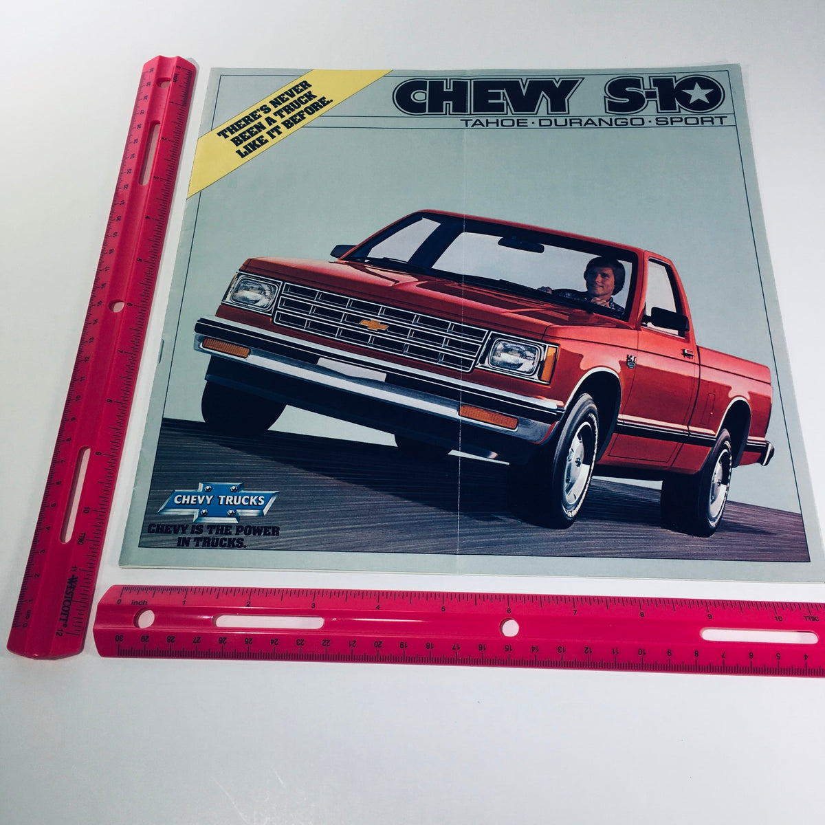 September 1981/4099 Chevy Trucks S-10 Tahoe Durango Sport Car Catalog Brochure displaying the red S-10 pickup truck alongside a measuring ruler for scale.