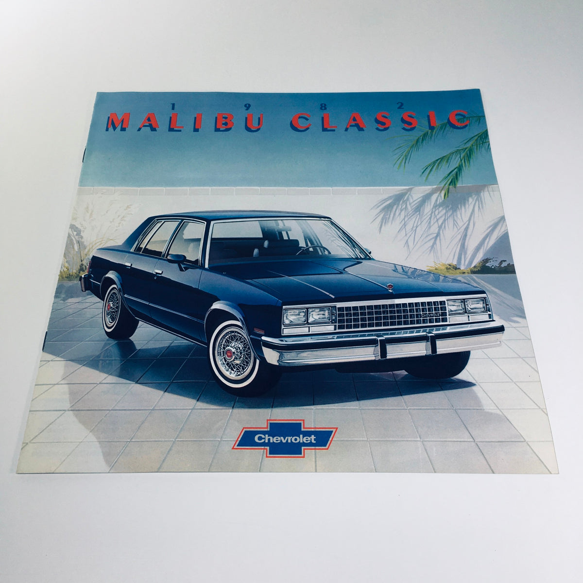 1982 Malibu Classic Chevrolet July 1981 Issue 4083 Car Catalog Brochure featuring a blue classic Chevrolet Malibu parked in a modern setting.