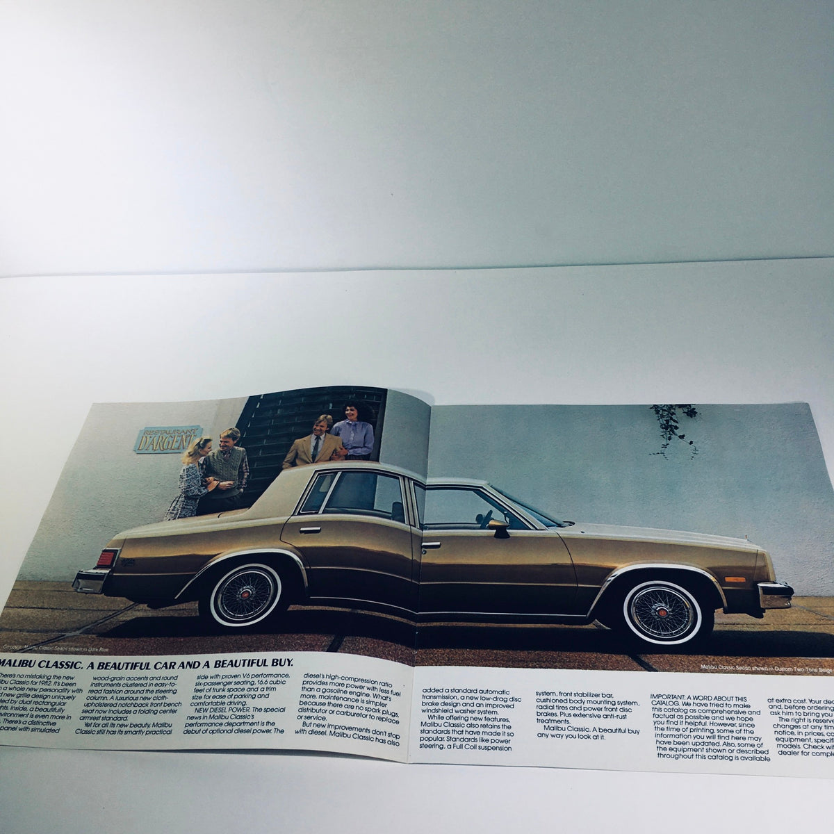 1982 Malibu Classic Chevrolet July 1981 Issue 4083 Car Catalog Brochure showcasing the exterior of a gold Malibu Classic with people standing beside it.