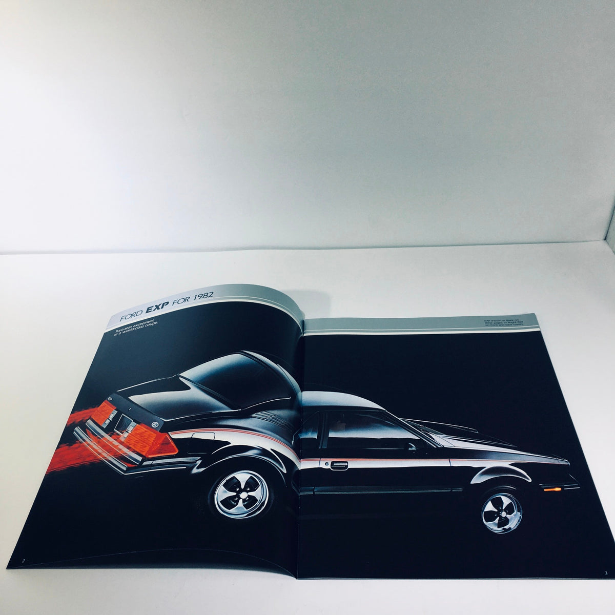 Inside view of the 1982 Ford Exp Two-Seat Hatchback World-Class Coupe brochure showcasing the rear end of a black Ford EXP.