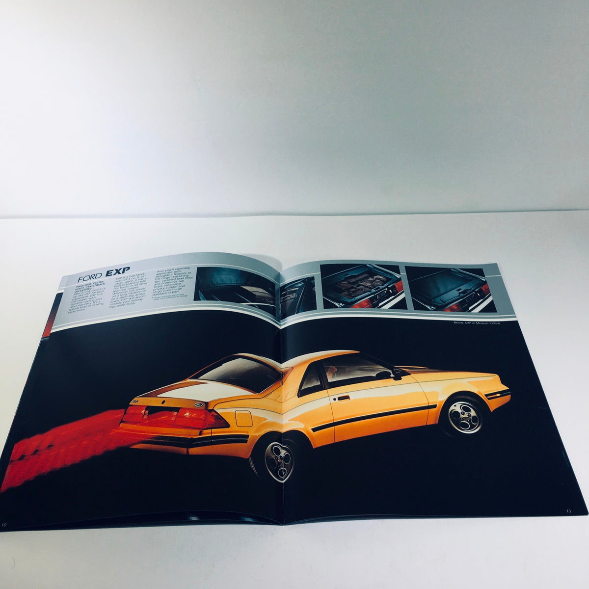 Inside view of the 1982 Ford Exp Two-Seat Hatchback World-Class Coupe brochure displaying a yellow Ford EXP from the rear.