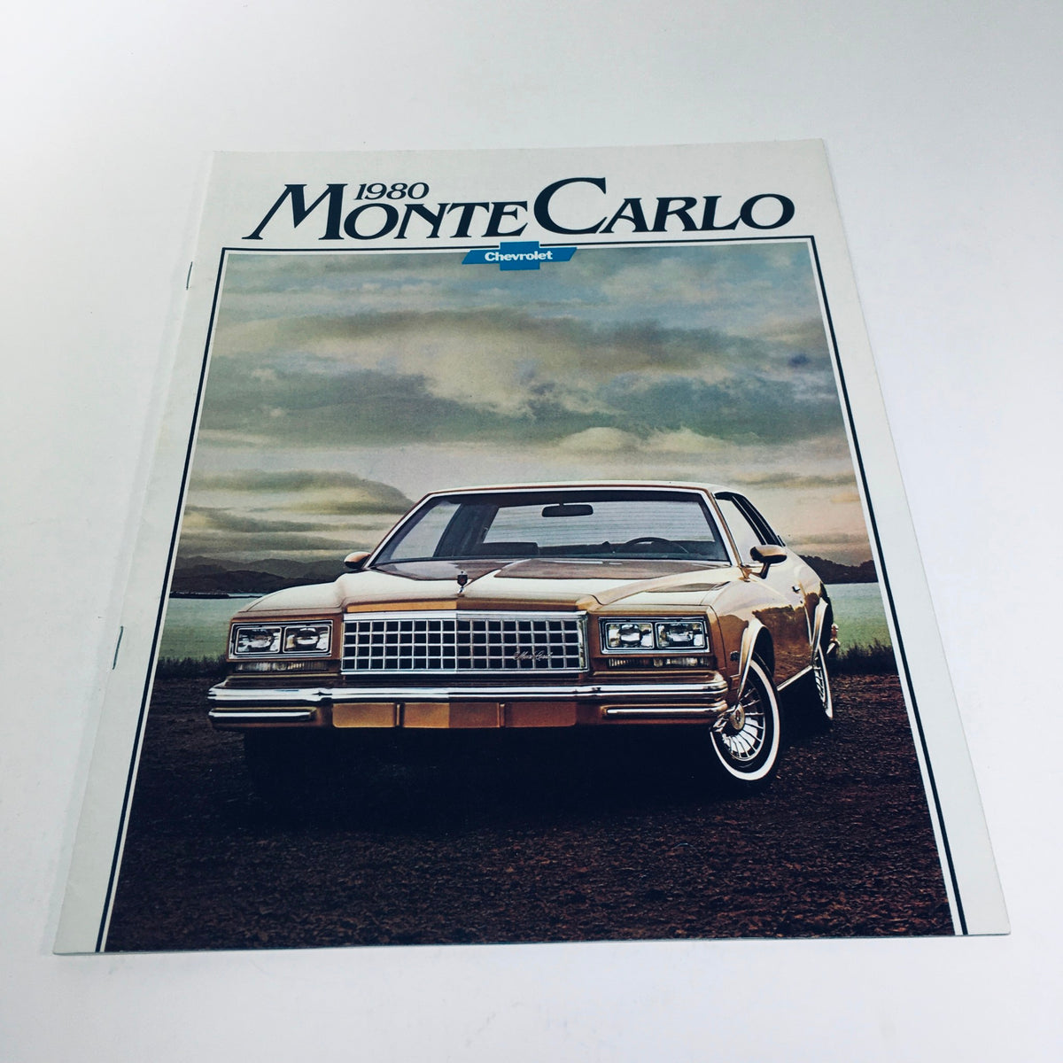 Front cover of the 1980 Chevrolet Monte Carlo Turbocharge V6 car sale brochure showing the car's sleek design and powerful stance against a scenic background.
