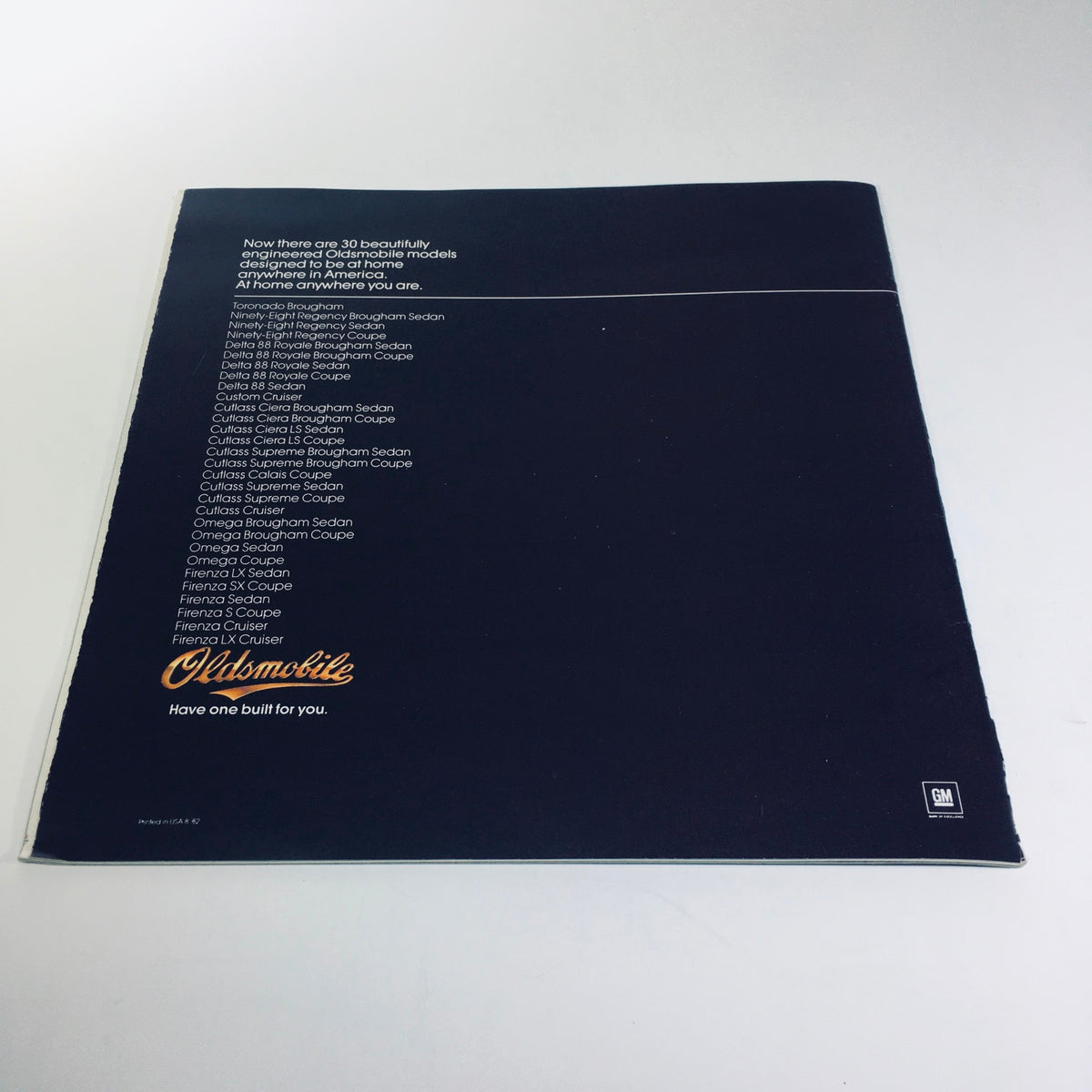 Back cover of the 1983 Oldsmobile Toronado Ninety-Eight Regency Delta 88 Custom Car Brochure, featuring a list of various Oldsmobile models at the bottom with a sleek dark background.