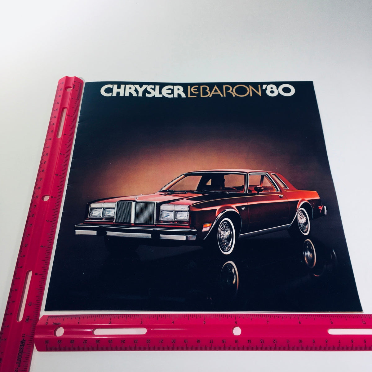 Front cover of the 1980 Chrysler LeBaron Four-Door Medallion MOPAR Parts Car Sale Brochure, displaying the stylish car design.