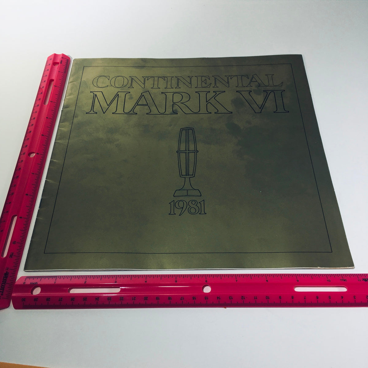 Front view of the 1981 Continental Mark VI Signature Series Form No. P-100 Car Sale Brochure, showcasing the stylized title and vintage design with a measuring ruler for scale.