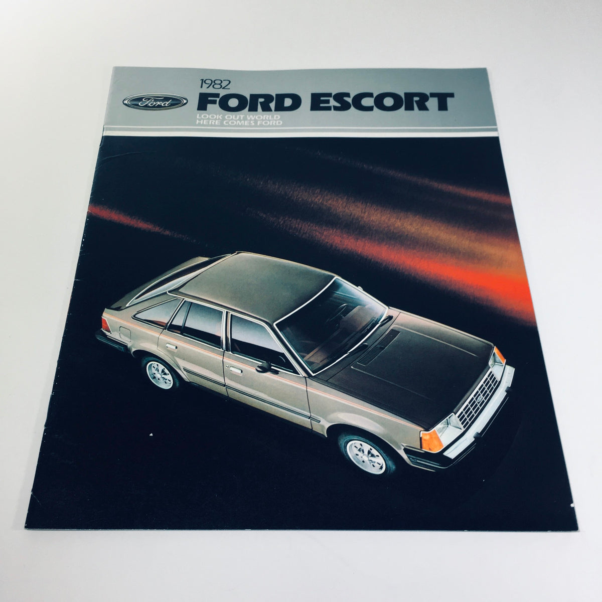 Cover of the 1982 Ford Escort GL Series 2-Door Hatchback brochure showcasing the vehicle from an angle with a sleek profile design.