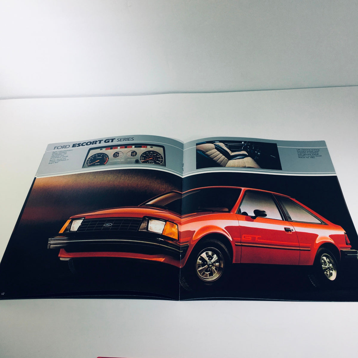 Detailed view of the 1982 Ford Escort GT Series brochure displaying the red hatchback, dashboard, and interior options.
