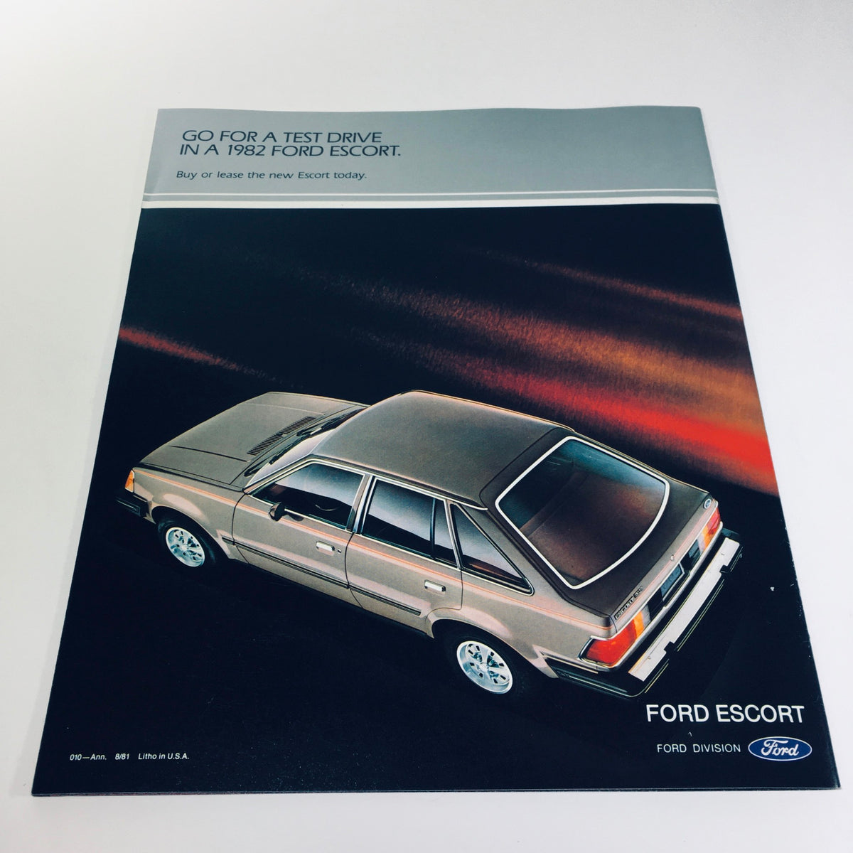 Cover of the 1982 Ford Escort brochure, emphasizing a stylish 4-door hatchback inviting potential buyers to test drive the vehicle.