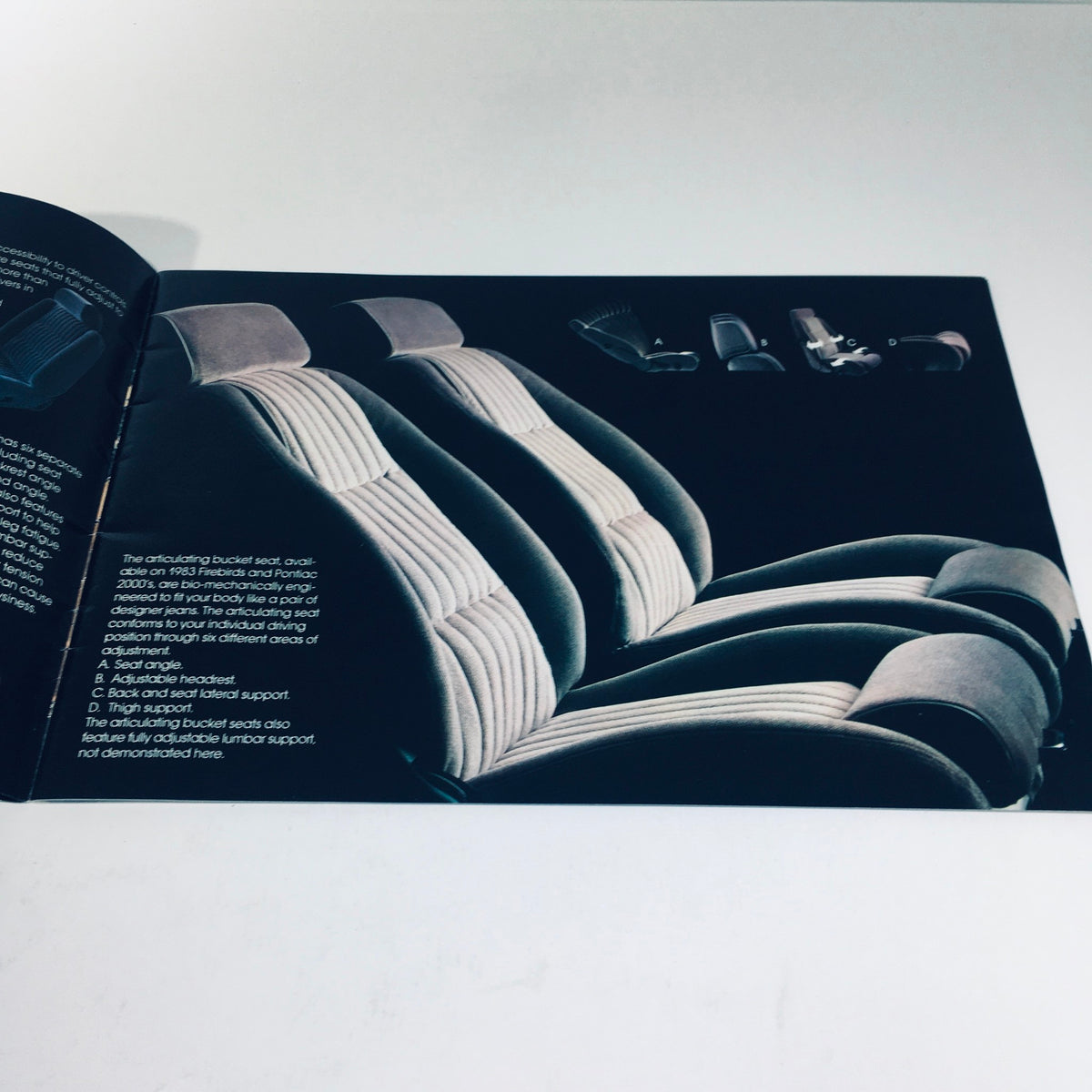 Detailed image of the seating options in the 1983 Pontiac 6000 brochure, featuring articulating bucket seats.
