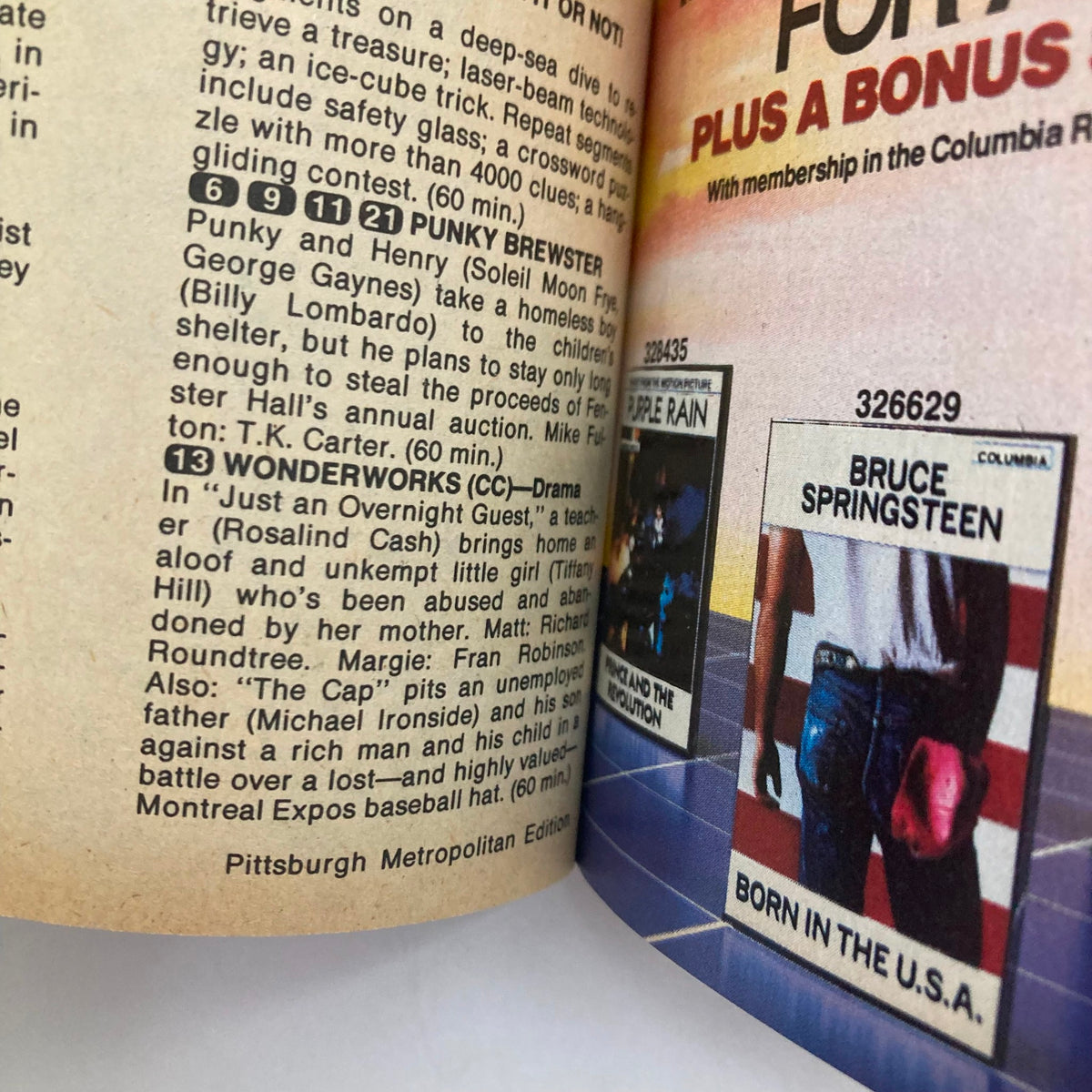 Inside view of the TV Guide Magazine from March 30, 1985 showing programming listings including the episode 'Wonderworks' and advertisements for albums, showcasing detailed editorial content.