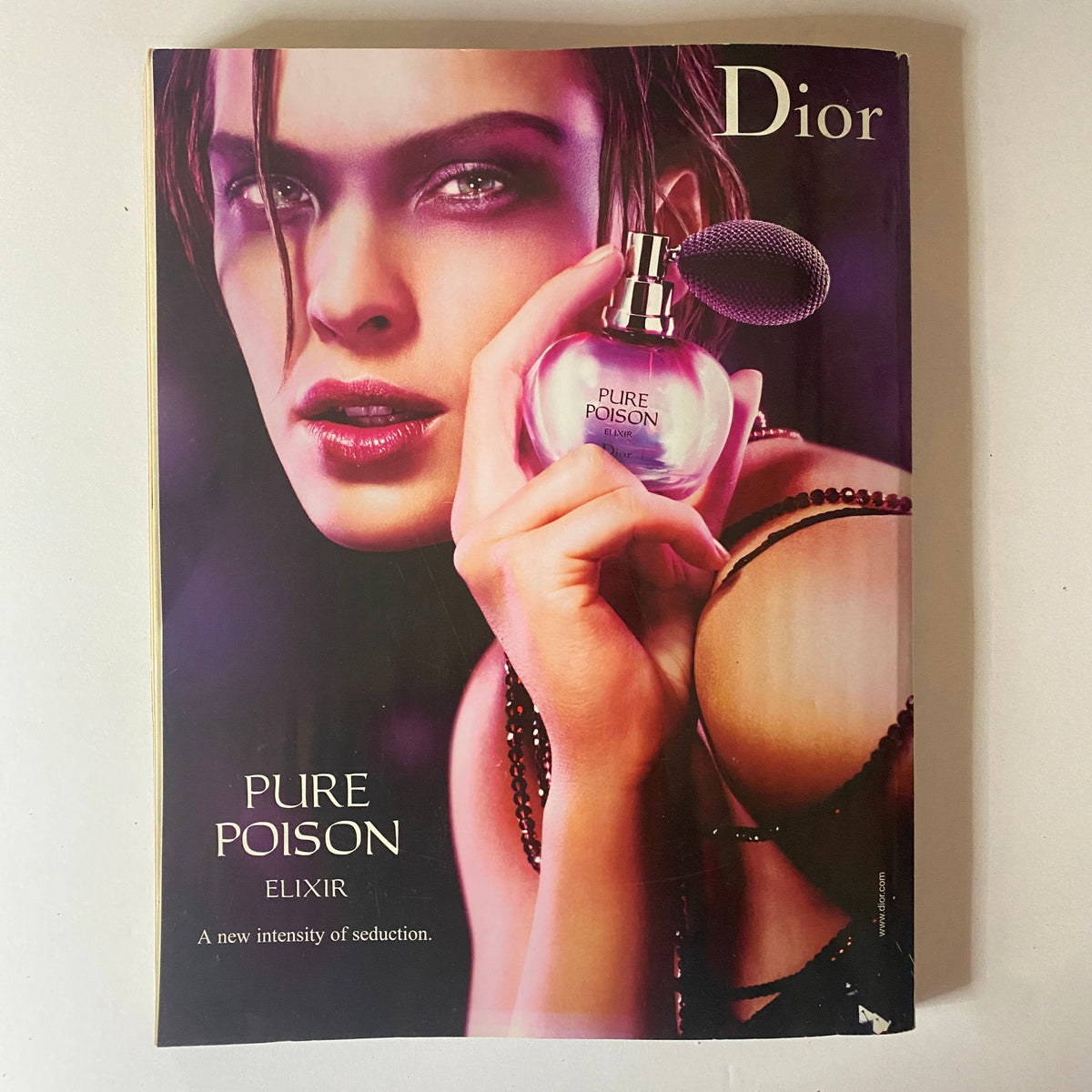 Advertisement for Dior's Pure Poison Elixir included in Elle UK Magazine December 2006, highlighting a seductive perfume.