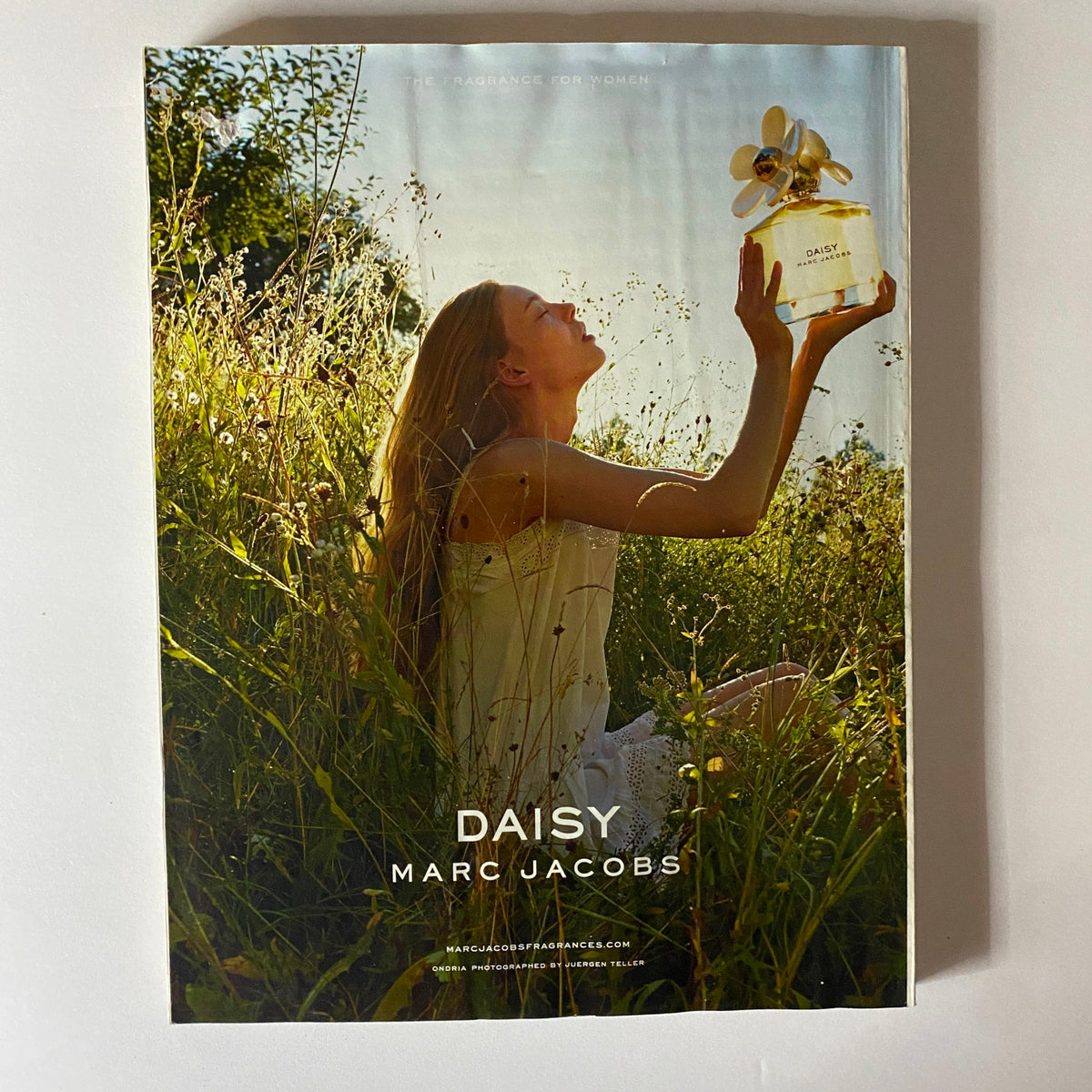 Elle UK Magazine April 2014 cover image featuring a model in a field with Daisy Marc Jacobs perfume, capturing the essence of spring fashion trends.