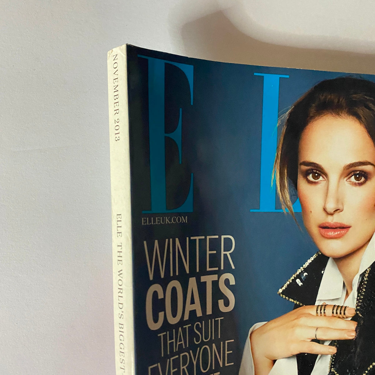 Close-up view of the Elle UK Magazine November 2013 cover showcasing the header Winter Coats that Suit Everyone and featuring Natalie Portman.