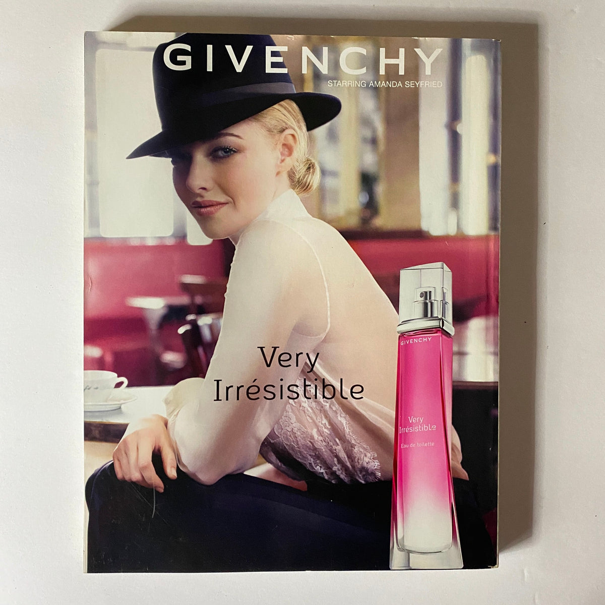 Elle UK Magazine November 2013 with a Givenchy advertisement starring Amanda Seyfried, highlighting the 'Very Irresistible' fragrance in a chic café setting.
