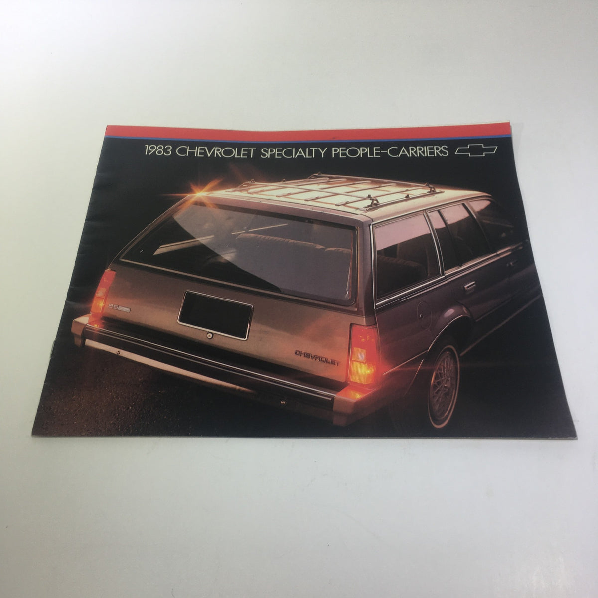 1983 Chevrolet Specialty People-Carriers Caprice Classic V-8 Engine car brochure showcasing the rear view of the vehicle, emphasizing its design features.