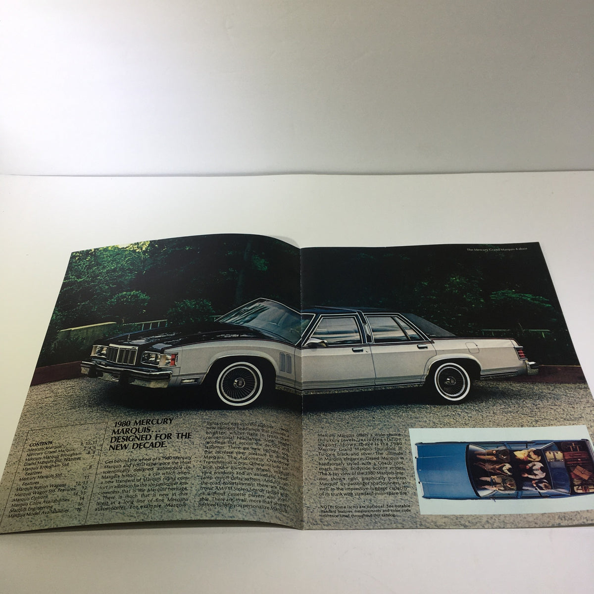 Interior view of the 1980 T980 Mercury Marquis 5.2 Liter 302 CID V-8 Engine Car Sale Brochure opened to display the white Mercury Marquis on a driveway.
