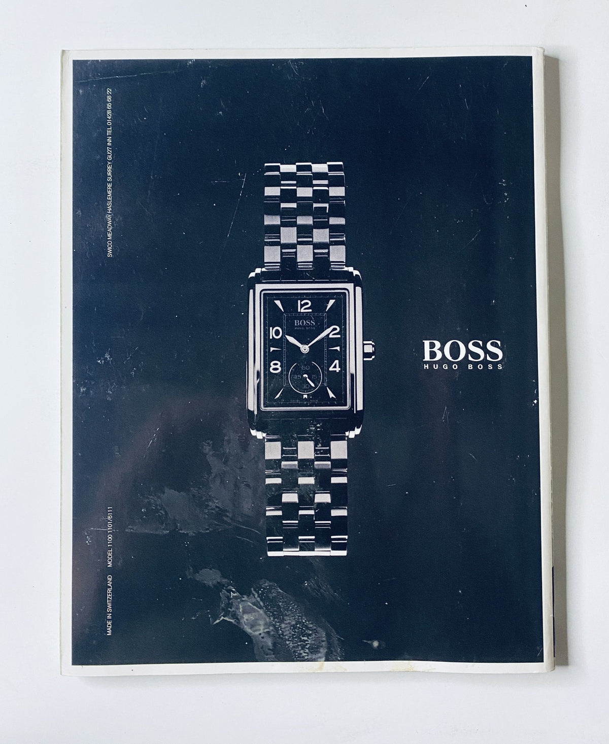 CAR Magazine February 2001 advertisement for Hugo Boss watch, showcasing sleek design and sophistication, complemented by luxury branding.