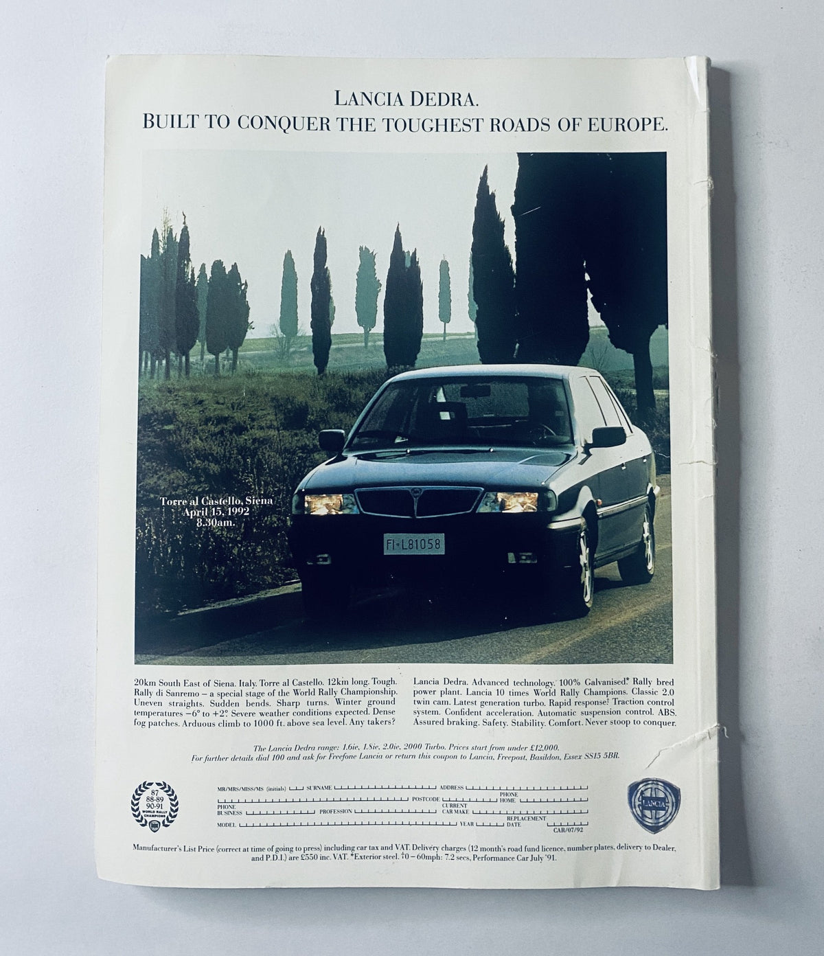 Lancia Dedra car advertisement showcasing its capability to conquer the toughest roads in Europe. Features a scenic background of tall trees and open landscape, promoting the vehicle's advanced technology and design. Associated with the product title: Car Magazine August 1992 Jaguar XJ220 Ferrari 512TR Lamborghini Diablo Review.