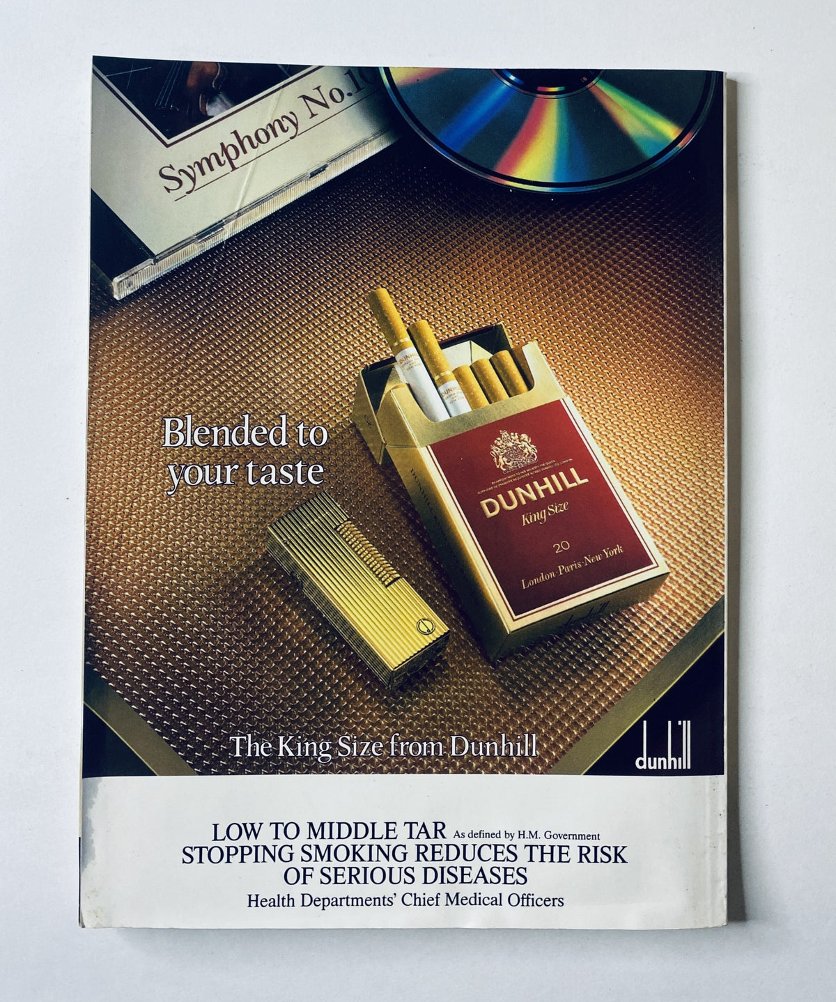 Advertisement for Dunhill cigarettes from Car Magazine February 1988, showcasing a King Size pack and lighter with a tagline 'Blended to your taste'.