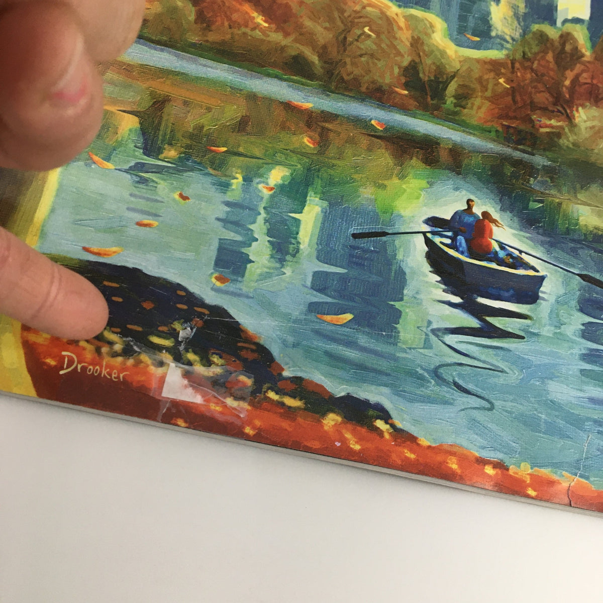 Close-up of The New Yorker November 12 2018 magazine cover, showcasing Eric Drooker's signature and detailed artwork of a tranquil water scene with autumn colors and two figures in a boat.