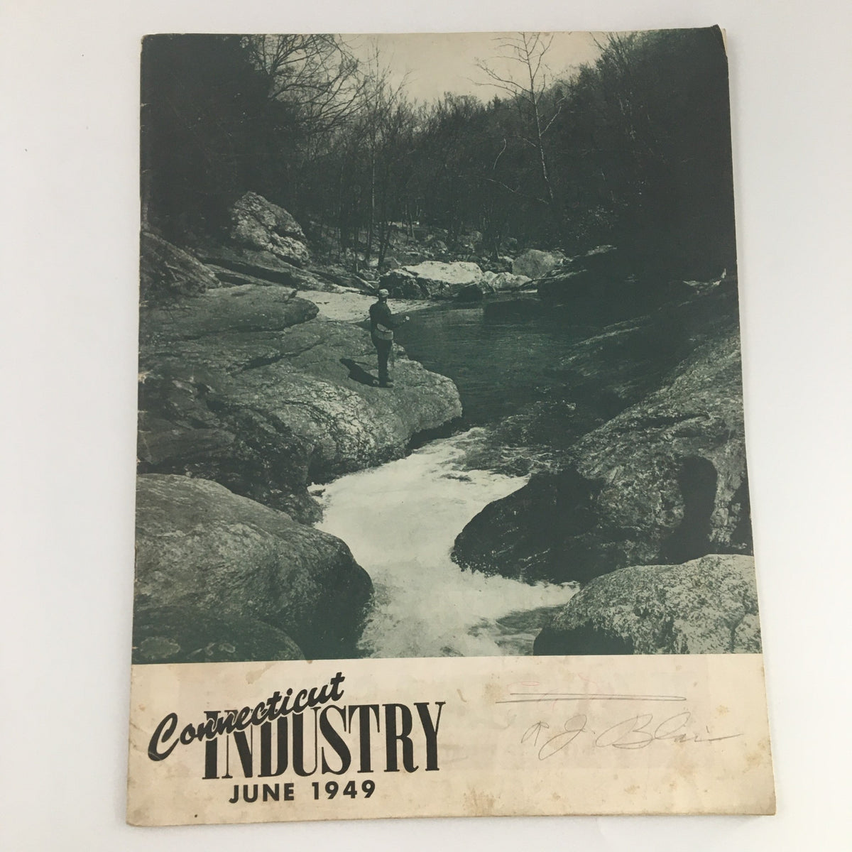 VTG Connecticut Industry Magazine June 1949 featuring a black and white photograph on the cover, showcasing a man standing by a river surrounded by a rocky landscape.