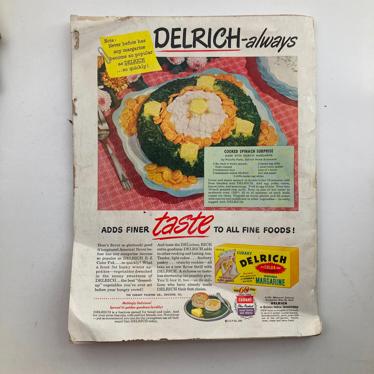 Cover of VTG Woman's Day Magazine February 1950 featuring tips on doll repairing, showcasing a vintage advertisement for Delrich margarine with a colorful dish of cooked spinach surprise and accompanying text.