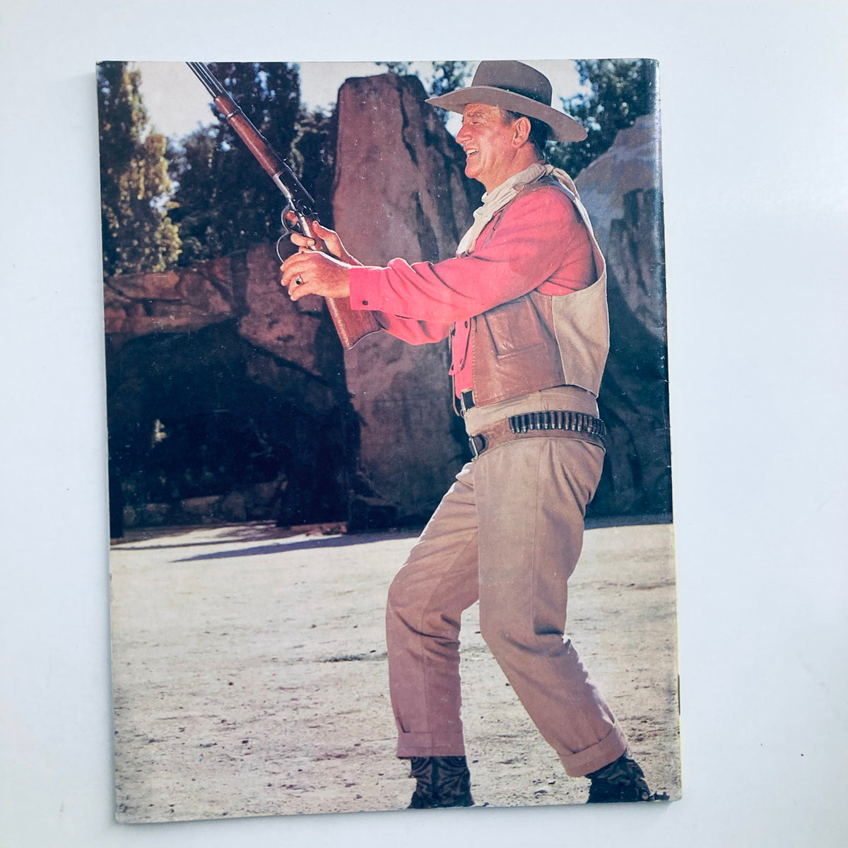 VTG 1979 A Tribute To John Wayne The Duke featuring John Wayne in a cowboy outfit holding a rifle, set against a natural backdrop, perfect for collectors of vintage cinema memorabilia.