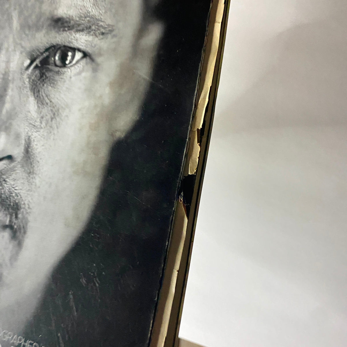 Close-up view of the edge of W Magazine February 2009 featuring A-list actor Brad Pitt cover, showing some wear and tear.