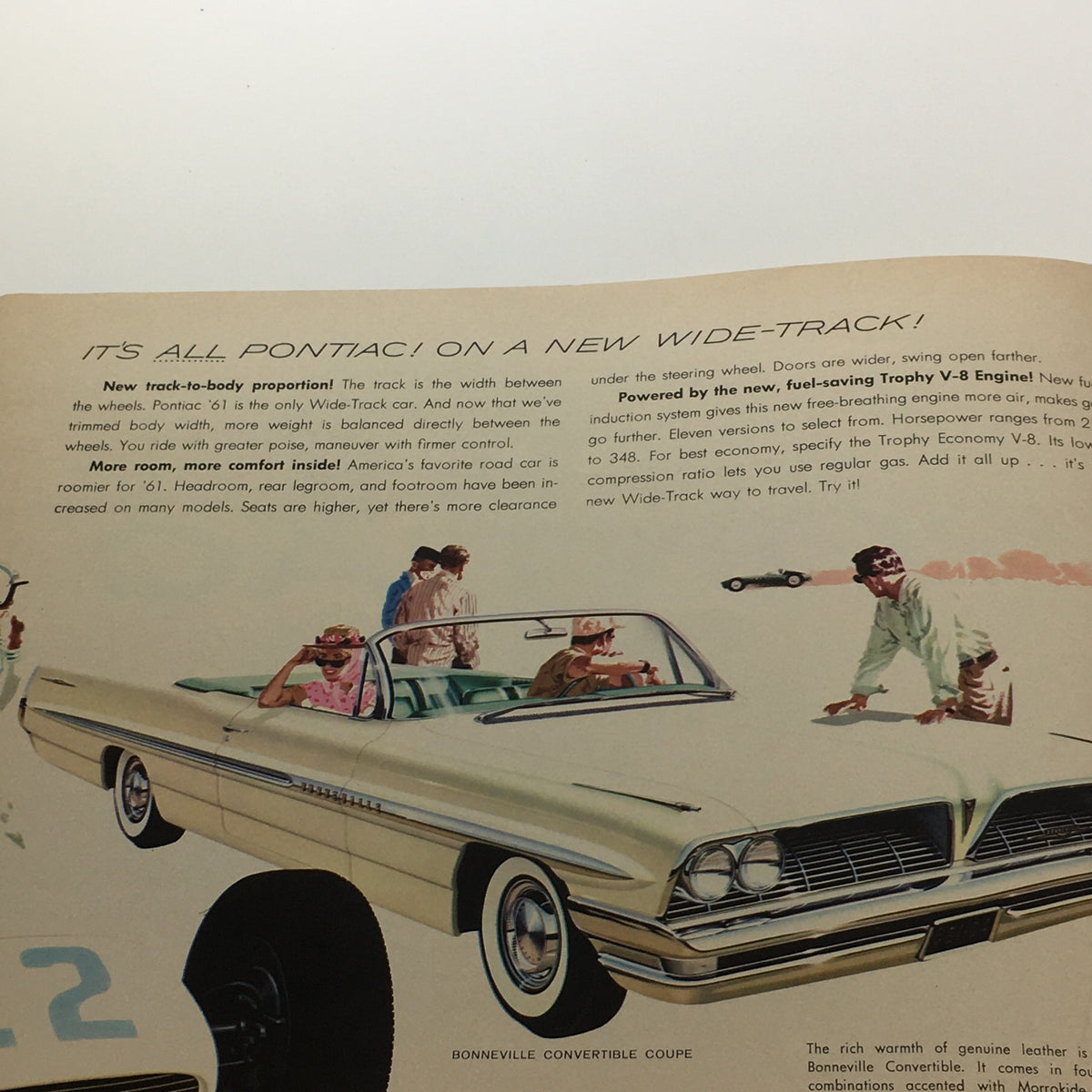 Interior page of the 1961 Pontiac Trophy Economy V-8 Engine 303-Horsepower Car Sale Brochure showcasing promotional imagery of Pontiac vehicles and features.