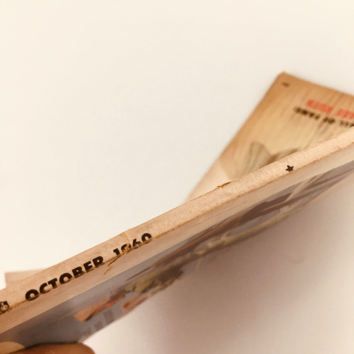 Close-up of the spine of VTG Sport Magazine October 1960, indicating minor wear, emphasizing its vintage character and authenticity.