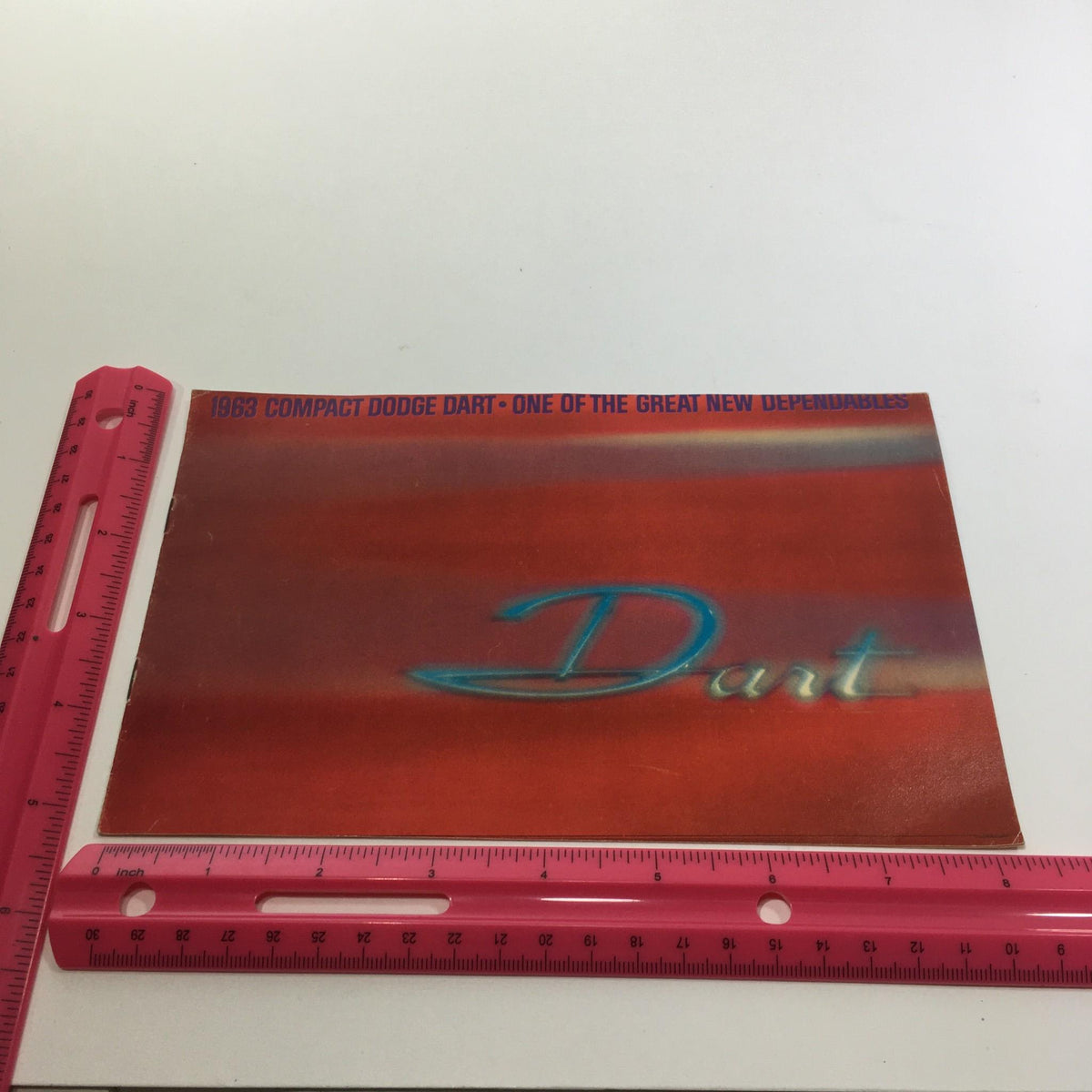1983 Compact Dodge Dart 270 Series 2-Door Convertible Sedan Car Catalog Brochure, shown with a ruler for size reference, featuring a bold red cover.